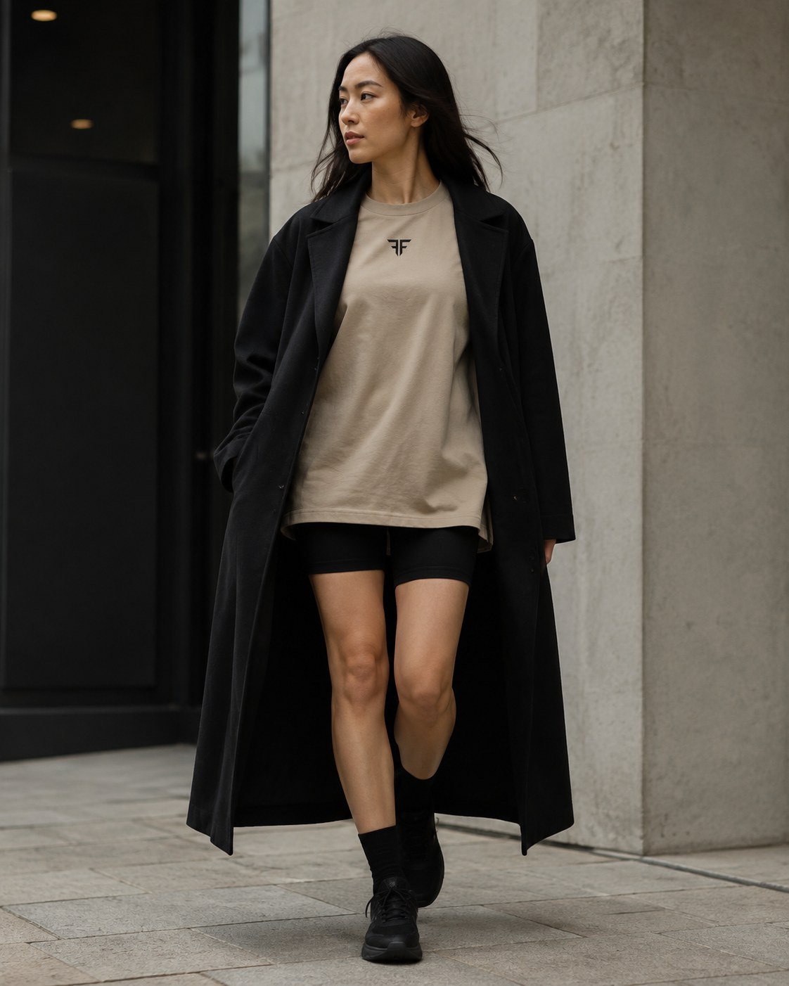 Faith Above Fear — stone oversized tee layered under a long black coat