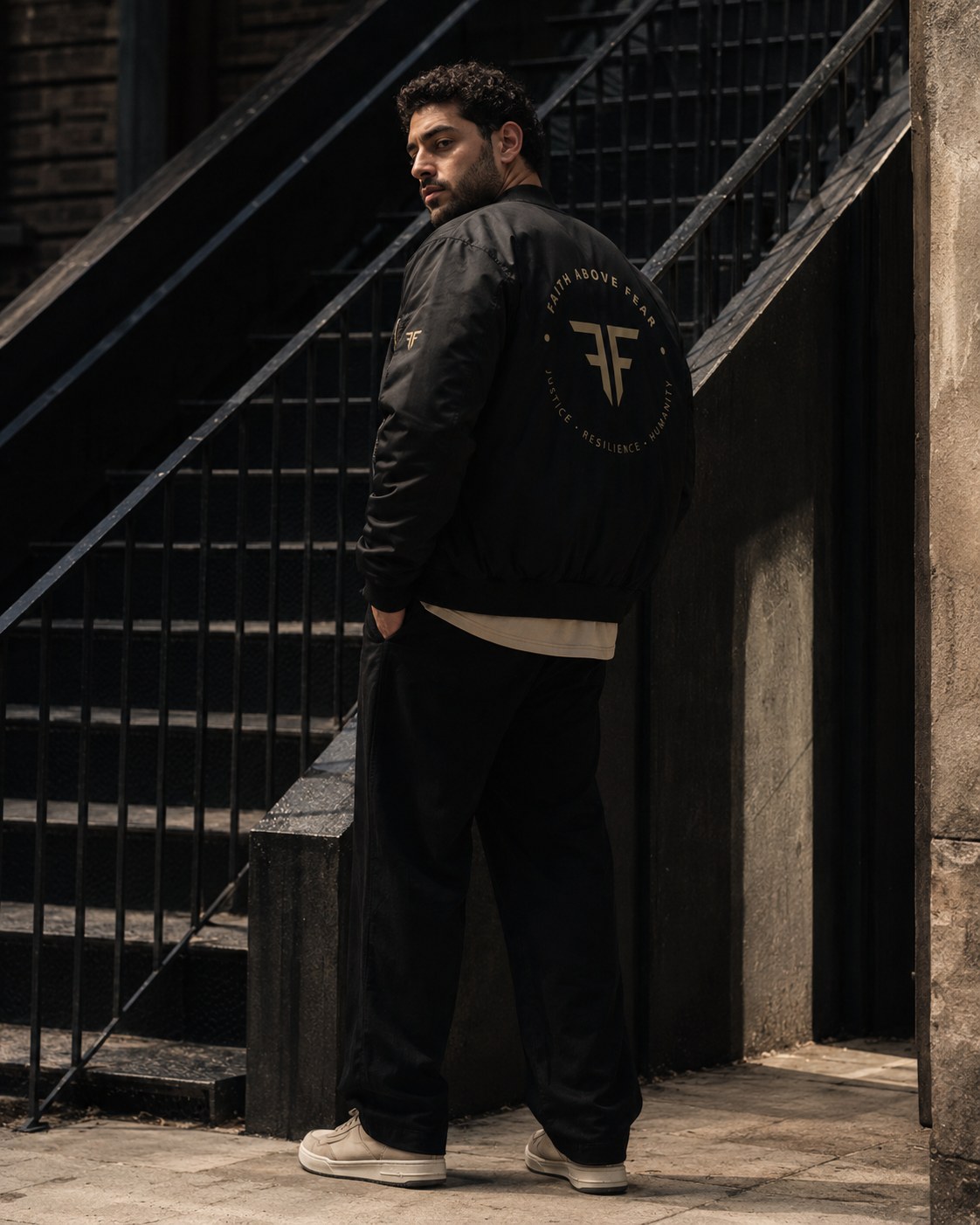 Faith Above Fear men's campaign — bomber jacket worn on the street